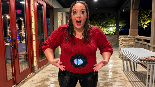 Woman dressed as Helen from Death Becomes Her with an illusion hole in her stomach that you can actually see through